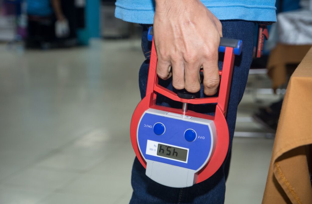 A close up of a person using a dynamometer to test their grip strength, a key indicator of overall strength, health, and longevity.