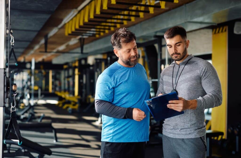 A personal trainer working with a man to increase overall strength with an efficient, effective, and customized program.